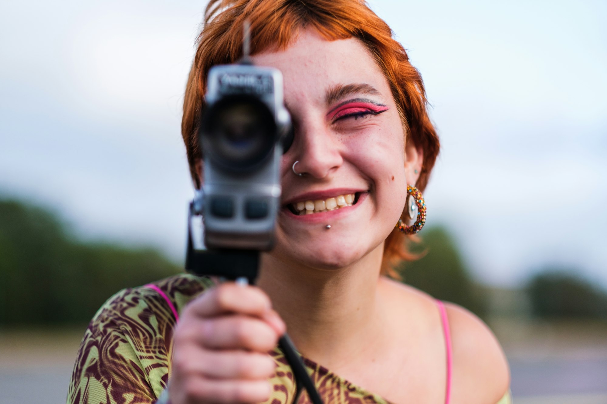 Teen girl holding vintage camcorder on movie shoot